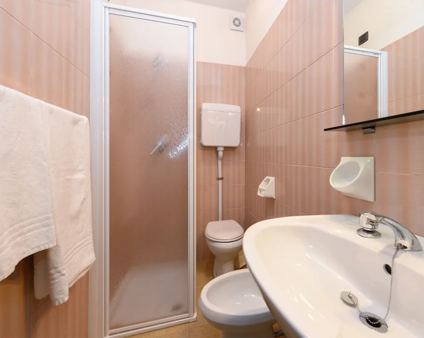 Compact bathroom with shower, toilet and sink near Lake Garda