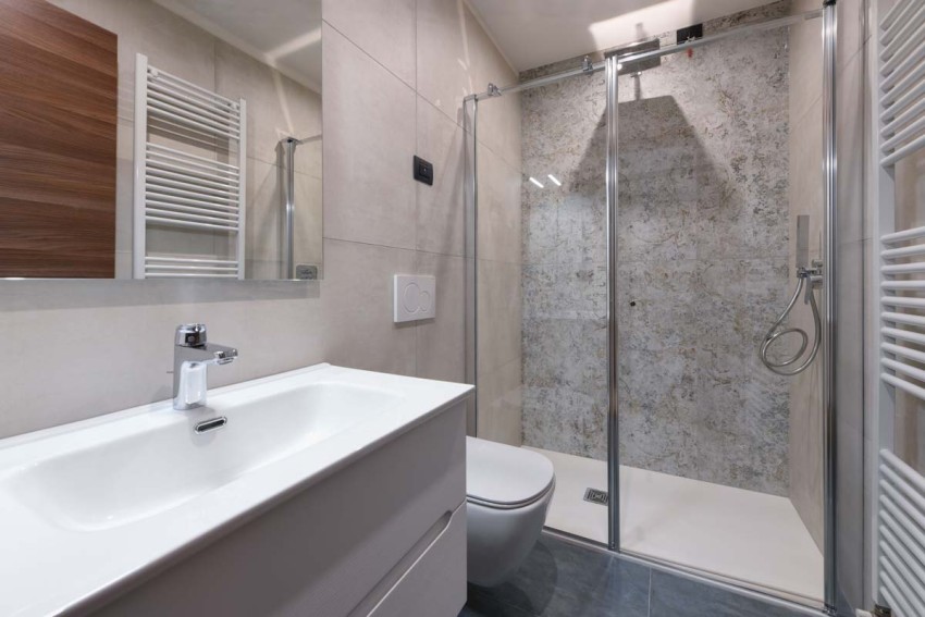 Modern bathroom with glass shower, sink and wall toilet, Lago di Garda