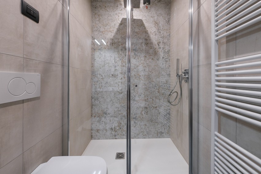 Modern walk-in shower with glass and towel radiator, near Lago di Garda